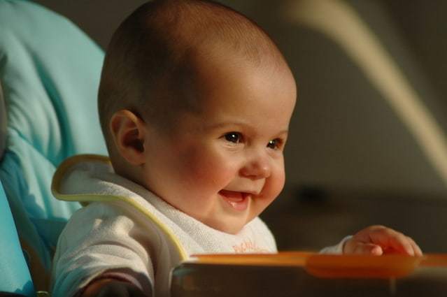 baby in highchair When to start solid foods | New Ways Nutrition