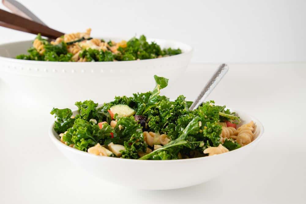 This easy kale salad recipe is a great clean out the fridge meal! It's full of healthy ingredients, with a super simple balsamic dressing to top it off. Enjoy this simple summer salad with your family today! #healthyrecipes #healthykalesalad