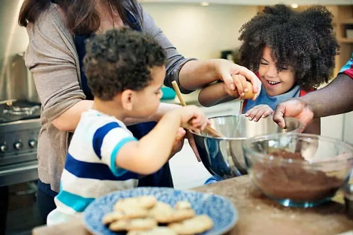 Kids and parents cracking eggs