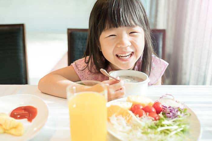 kid at family table