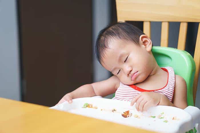 toddler sleeping in chair