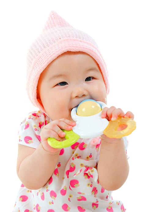 baby on white background chewing on baby toy