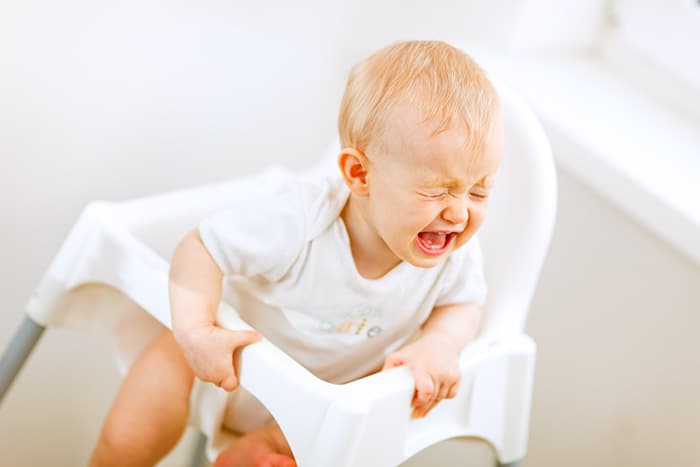 Baby crying in high chair