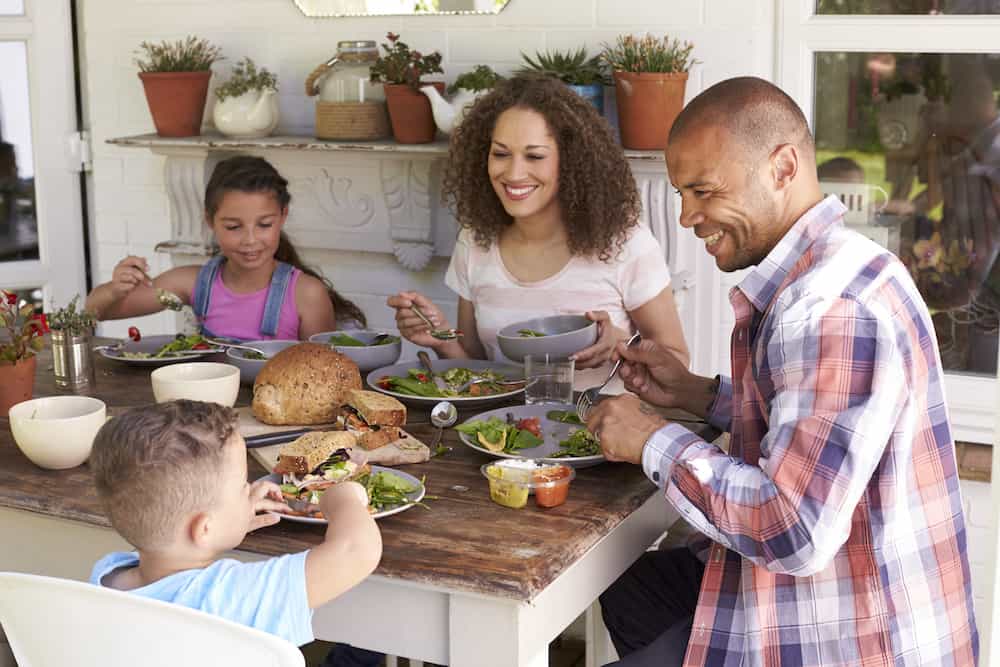 family eating together and smiling at table